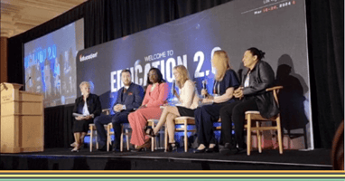 Panel of speakers on stage at an event