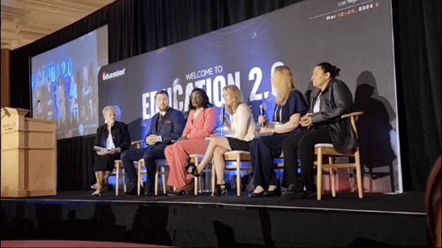 Panel of speakers on stage at an event