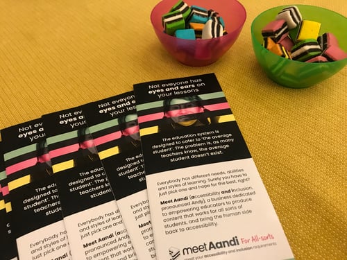 flyers laid out next to a bowl of colourful sweets